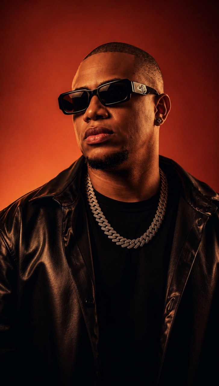 DJ Erick Familia — close-up portrait with red background