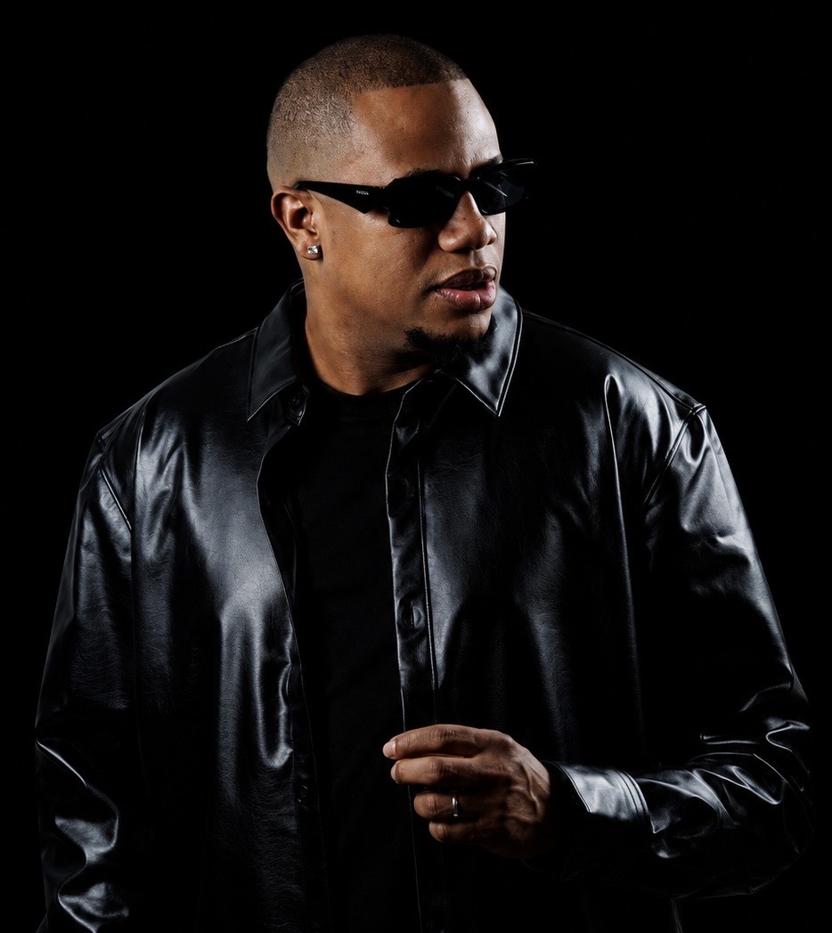 DJ Erick Familia — black studio portrait looking to the side