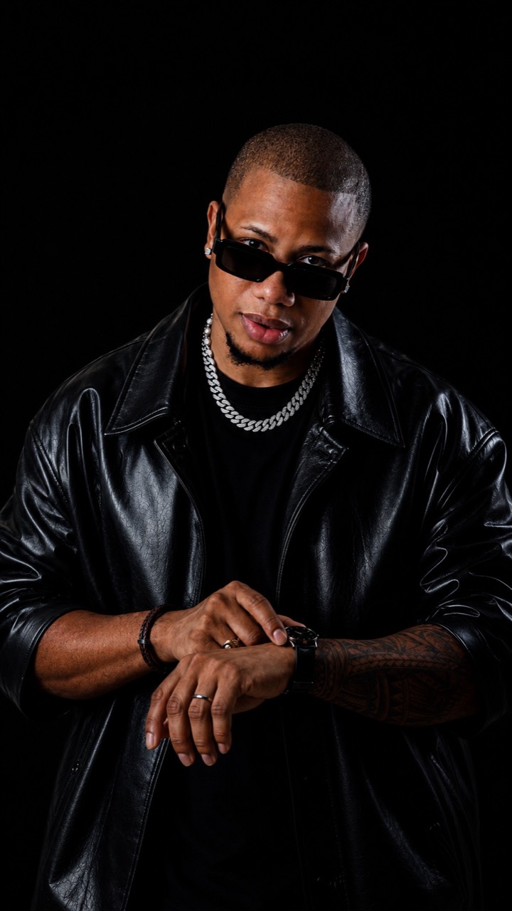 DJ Erick Familia — seated black studio portrait